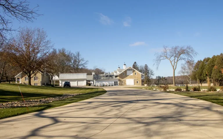 Long rural driveway leading to homes and garages in Eagleville, TN