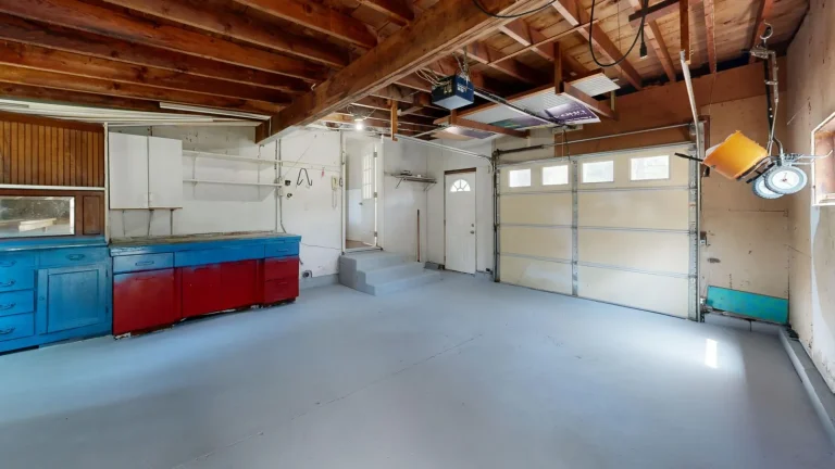 Garage interior with sectional door, tracks and opener, torsion spring replacement