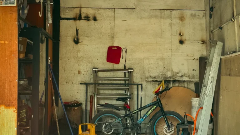 Garage interior showing the door tracks and rollers, track repair service