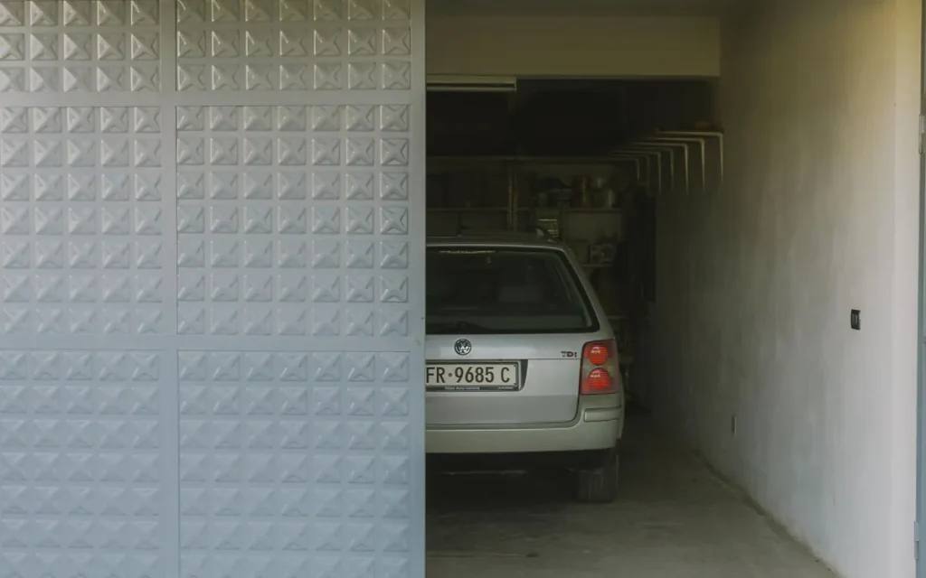 Open garage with a parked car in La Vergne, TN