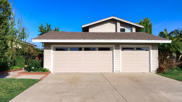 New white raised-panel garage doors installed on a home in Murfreesboro, TN