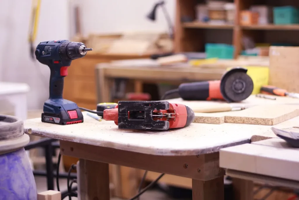 Power tools on a workbench for garage door maintenance