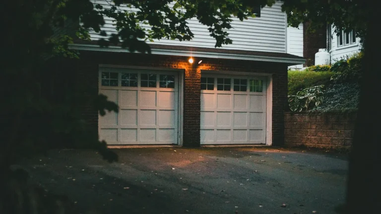 Double carriage-style garage doors on a brick home, residential garage door repair in Murfreesboro