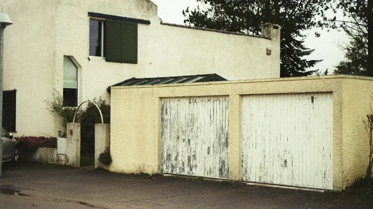 Weathered, peeling garage door panels that need panel replacement